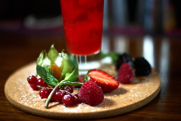 cocktail glass on the wood table in the bar. Slow motion