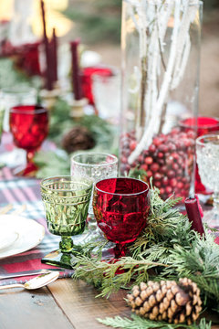 Red and green glasses on decorated holiday table
