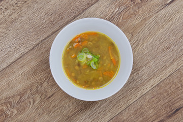 Lentil soup with carrot on a table