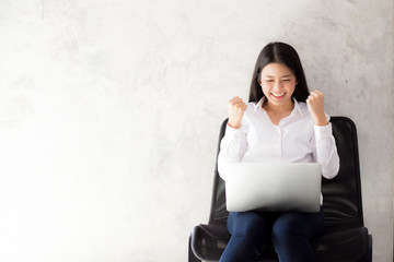Beautiful asian young woman excited and glad of success with laptop, girl working coffee shop on...