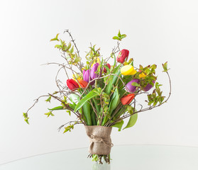 Spring bouquet of tulips with young twigs