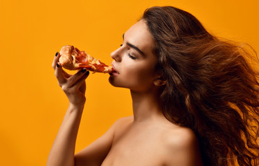 Young beautiful woman eat pepperoni pizza slice and hold whole pizza in box