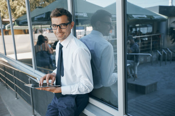 businessman with a tablet working outside