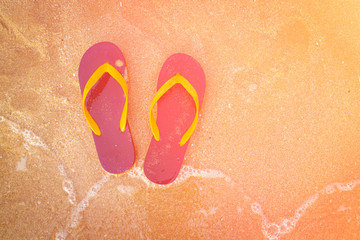 flipflop shoes on the beach in sunset time