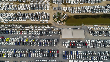 Aerial Top view of new cars lined up at Industrial factory Port, Logistics import - export and transportation concept