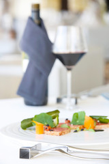 Exquisite salmon dish served with red wine, creative restaurant meal concept, haute couture food