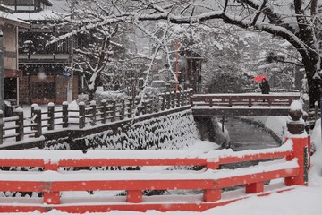 a white snowy town with some red