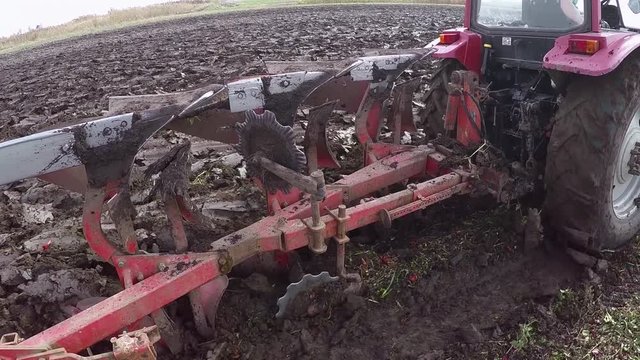Plowing of pepper field on cloudy fall day. Dolly gimbal video.