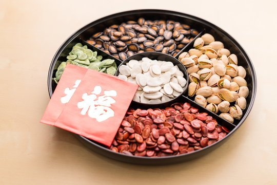 Snack tray for lunar new year with red packet of word means luck
