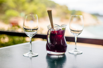 Jug with Sangriya and two glasses on the table