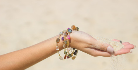 Brazilian blonde tanned on the beach with crystal jewelry
