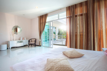 Luxury Interior design in bedroom of pool villa with cozy king bed. Bedroom with high raised ceiling 