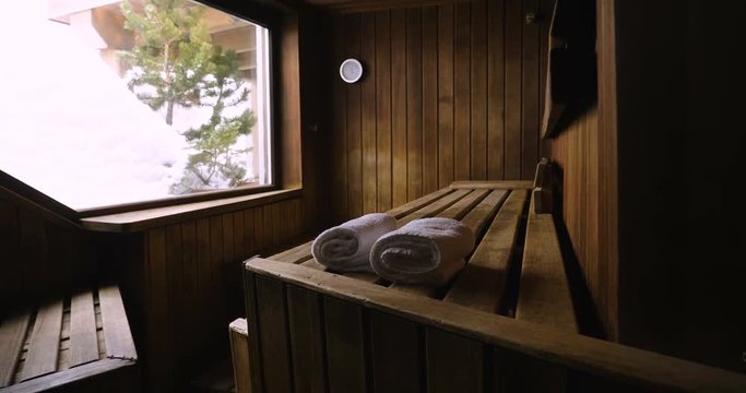 Location of a mountain wood sauna with a large window in which to relax. Concept of: interior design, relaxation, sauna, spa