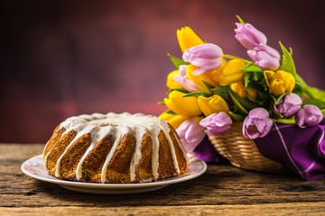 Easter Cake. Traditional ring marble cake withe easter decotation. Easter eggs and spring tulips.