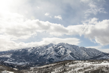snowy mountain peak landscape in wasatch mountain range during snow storm.