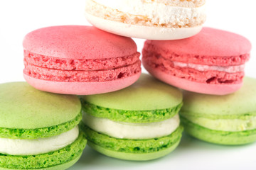 pink, green, white cookies lie pyramid isolated on white