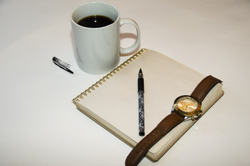 Morning businessman. coffee. notebook. a pen. clock