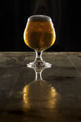 Imperial lager ale in goblet with overflowing head