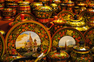 Khokhloma utensils. Kitchen tableware in Russian folk style. Wooden spoons and bowls in bright (red, yellow, golden) colors.