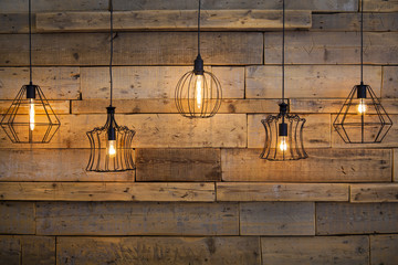 Lamps with warm light, for decoration, against the background of old wood