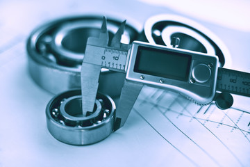Diameter measurement with calipers, bearings, toned.