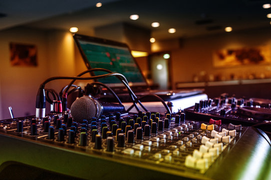 Sound Mixer Board And Microphone With Colored Disco Lights.