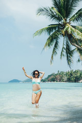 attractive girl in bikini having fun at tropical sea resort