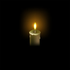 burning candle on a black background