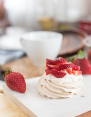 small meringue Pavlova dessert with strawberry