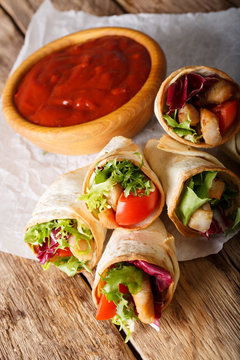Mini burrito with turkey and vegetables close-up on the table. vertical