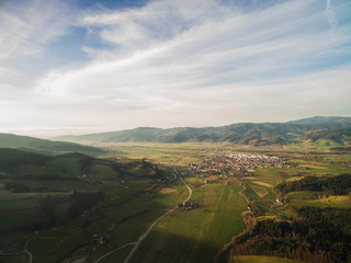 arial view of majestic landscape with field, hills and town in Germany