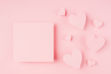 Blank pink sticker with paper hearts on light background. Concept art for Valentine day..