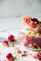 dried rose buds on turquoise wooden surface