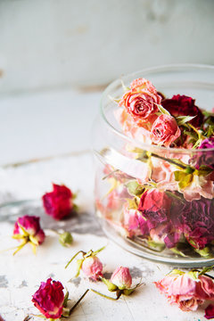Fototapeta dried rose buds on turquoise wooden surface