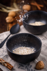 Levitating flakes of oatmeal. Still-life on a wooden background.