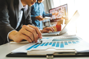 Team business meeting presentation. Hand businessman working   project in modern office.Laptop computer and tablet and smart phone on white desk in morning light
