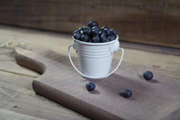 Fresh blueberries in a can.Standing on a chopping board