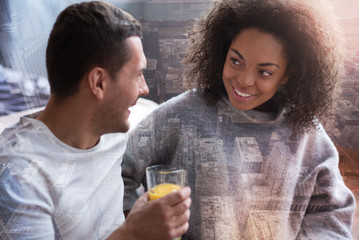 Perfect couple. Nice delighted positive woman looking at her boyfriend and smiling while spending time together