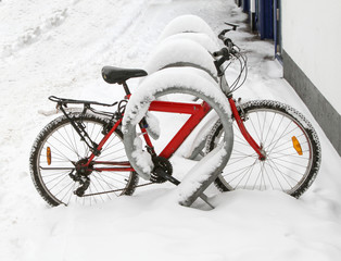Bicycle in the parking lot after a snowfall