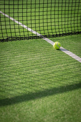 Paddle tennis court and net with a ball