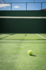 Paddle tennis court and net with a ball