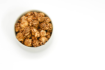Chocolate popcorn in white Bowl on white background. copy space.
