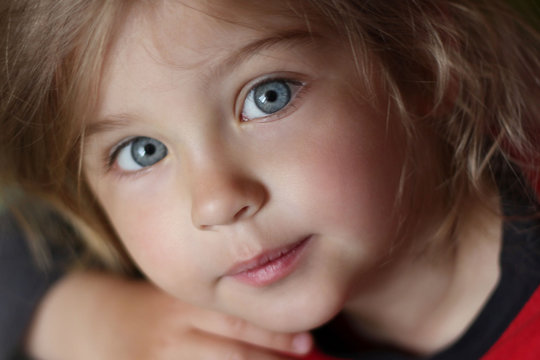 Close-up portrait of a cute smiling child with beautiful eyes