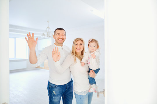  A Happy Family Opens The Door To Their Apartment. Housewarming.