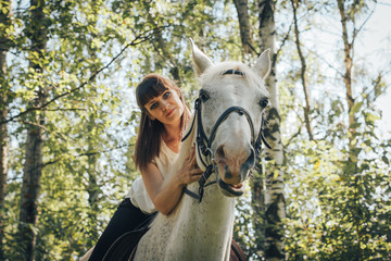 Obraz premium Girl and horse in the woods