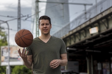 Man Holding Basketball in an Urban Setting