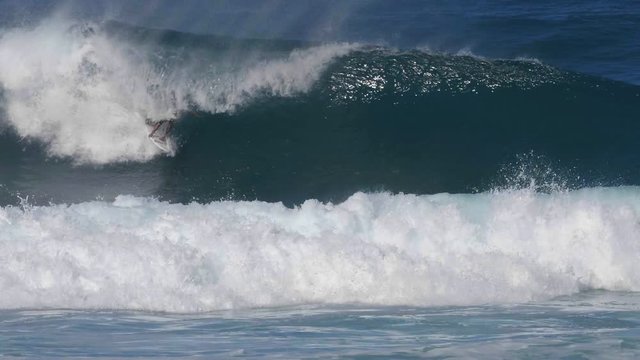 180p slow motion clip of a backhand tube and re-entry at pipeline on the north shore of oahu, hawaii