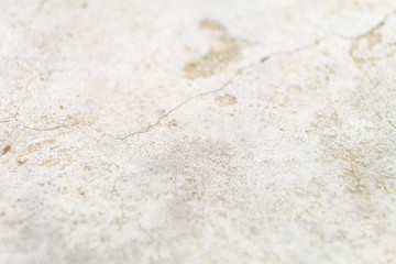 Surface cracked cement-sand mortar leveling screed. Bright blurred abstract background with limited depth of field.