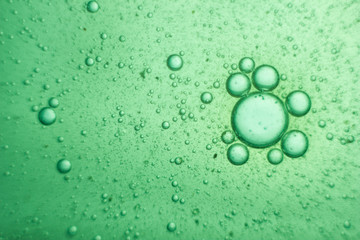 Green oil bubbles on water surface
