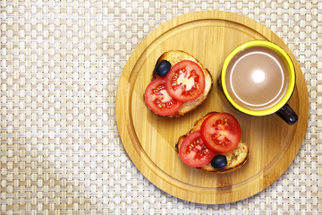 Healthy eating. Breakfast. Hot chocolate and two toasts with tomatoes and olives.